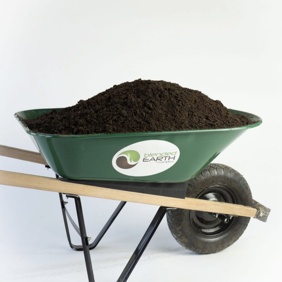 A green wheelbarrow filled with soil, labeled blended EARTH, against a white background.