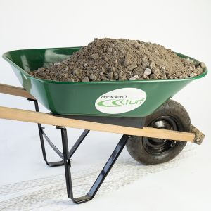 A green wheelbarrow filled with dirt and rocks on a white background.